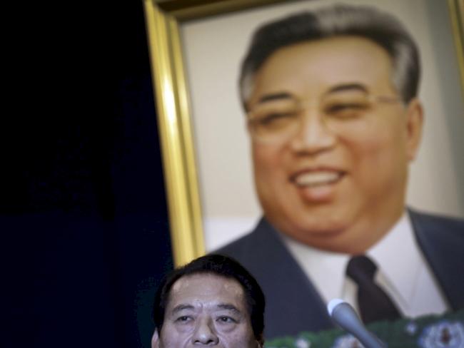 In this Aug. 28, 2014 photo, Japanese pro-wrestler-turned-politician Kanji "Antonio" Inoki sits in front of a portrait of the late North Korean leader Kim Il Sung during a press conference in Pyongyang, North Korea.  In an oddball attempt at sports diplomacy with North Korea, a group of about 20 mixed martial artists from around the world, including former NFL player Bob “The Beast” Sapp, traveled to Pyongyang last week to engage in arm-wrestling and tug-of-war competitions with local children.  (AP Photo/Wong Maye-E)